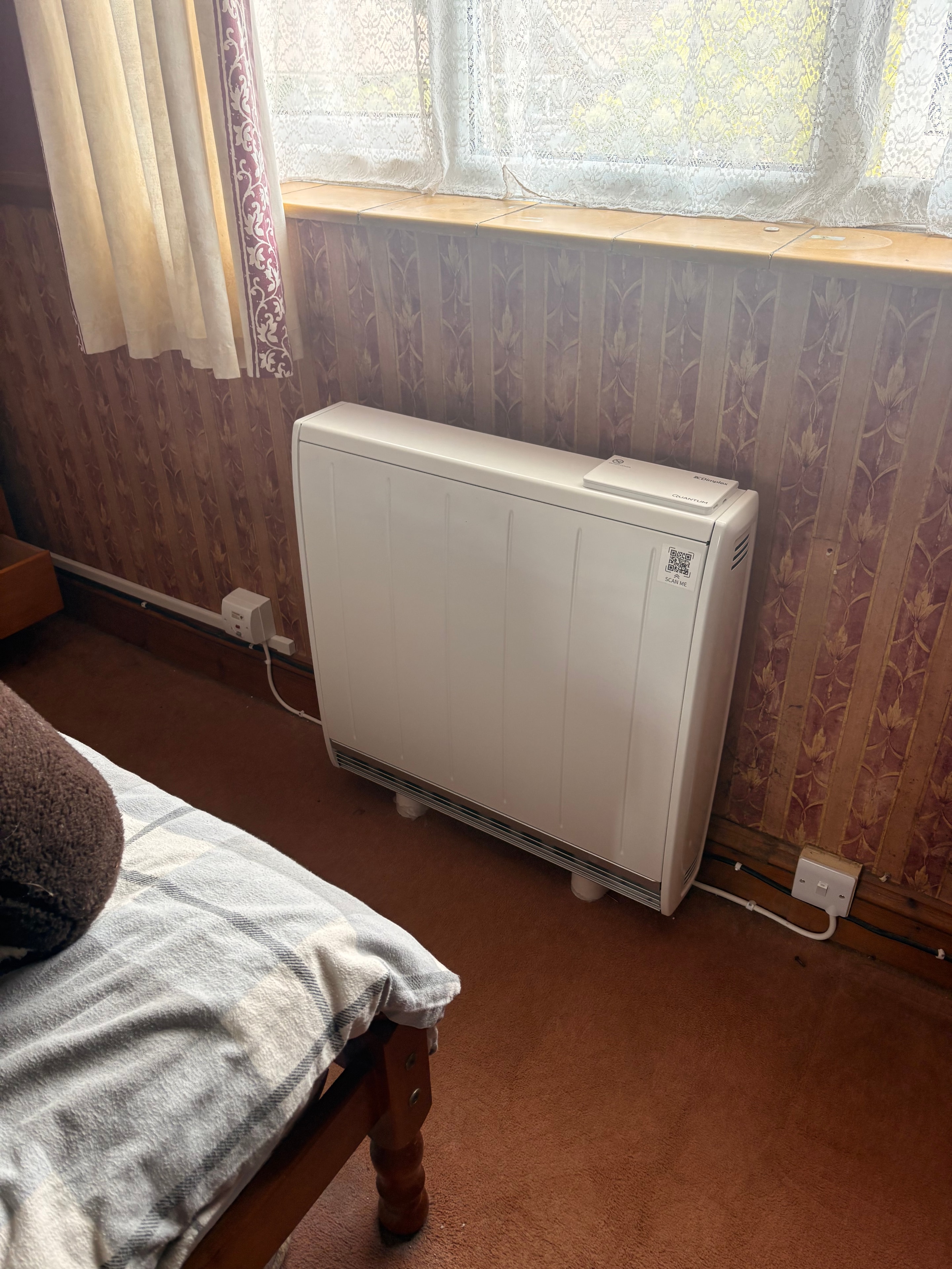 Completed storage heater on wall in second reception room — Goodmayes government grant installation