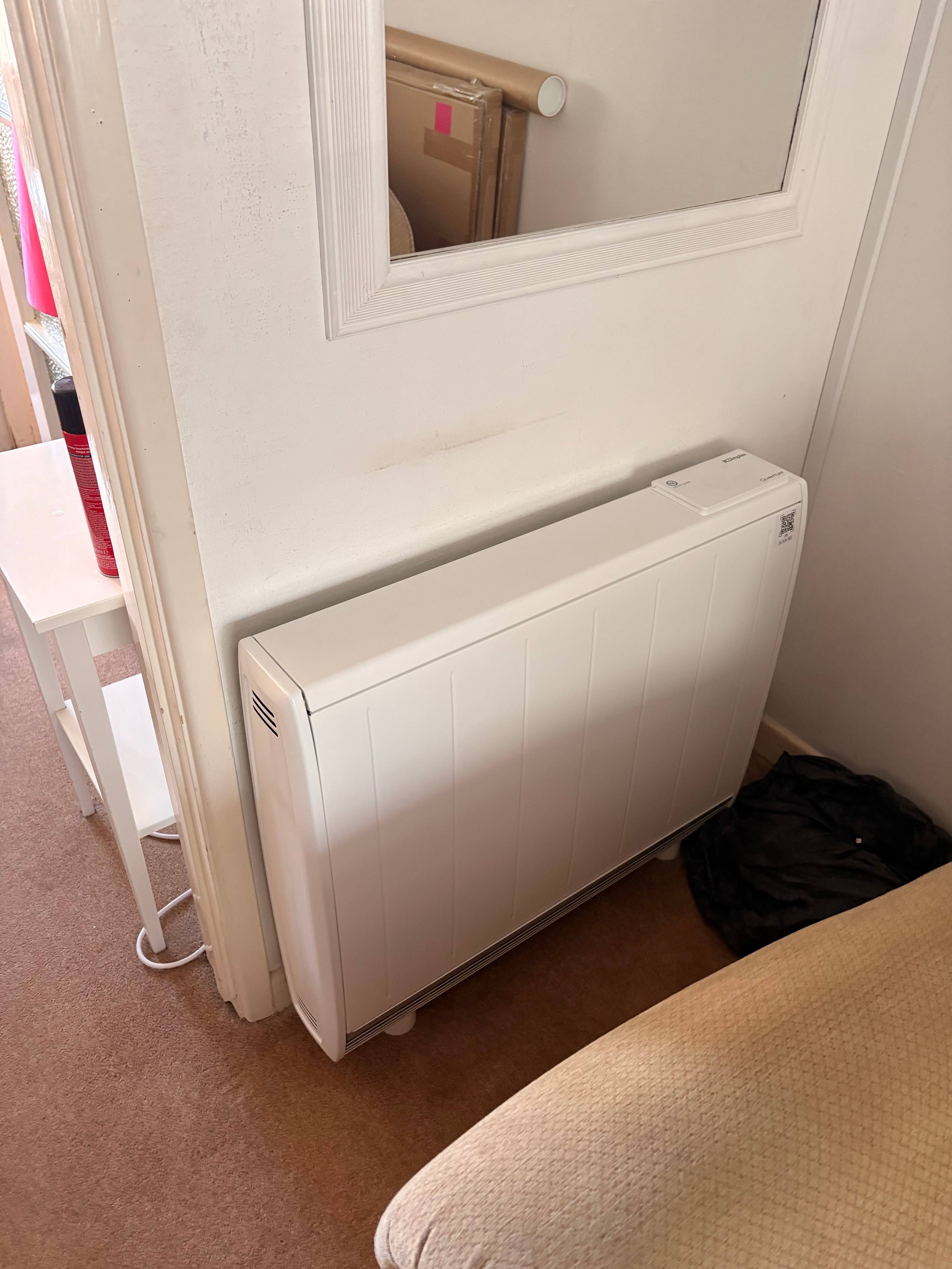 Completed storage heater installation in bedroom in Surrey — new unit on dedicated circuit