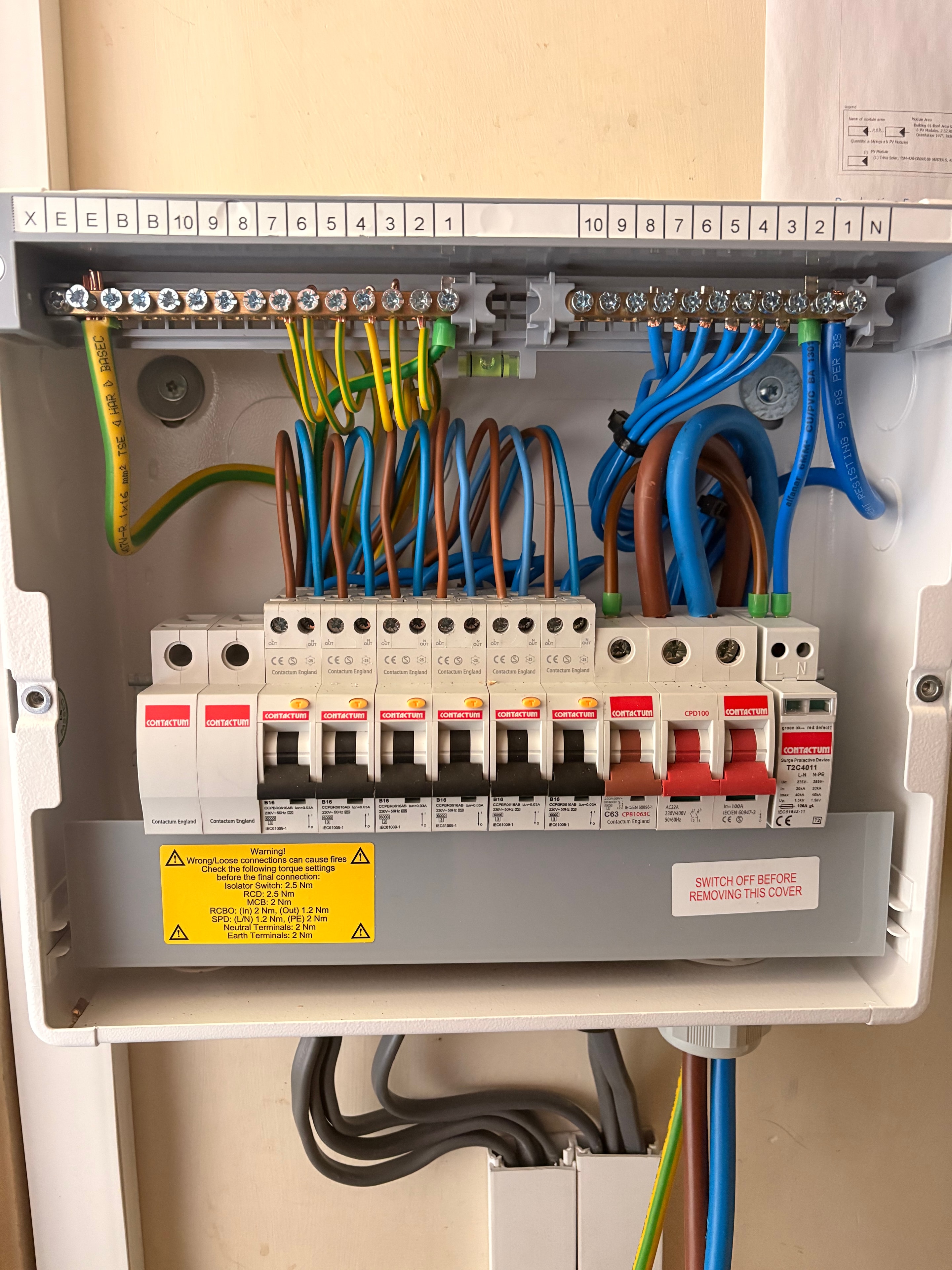 Detailed view of the consumer unit wiring showing three storage heater circuits with RCBOs and surge protection — Surrey installation