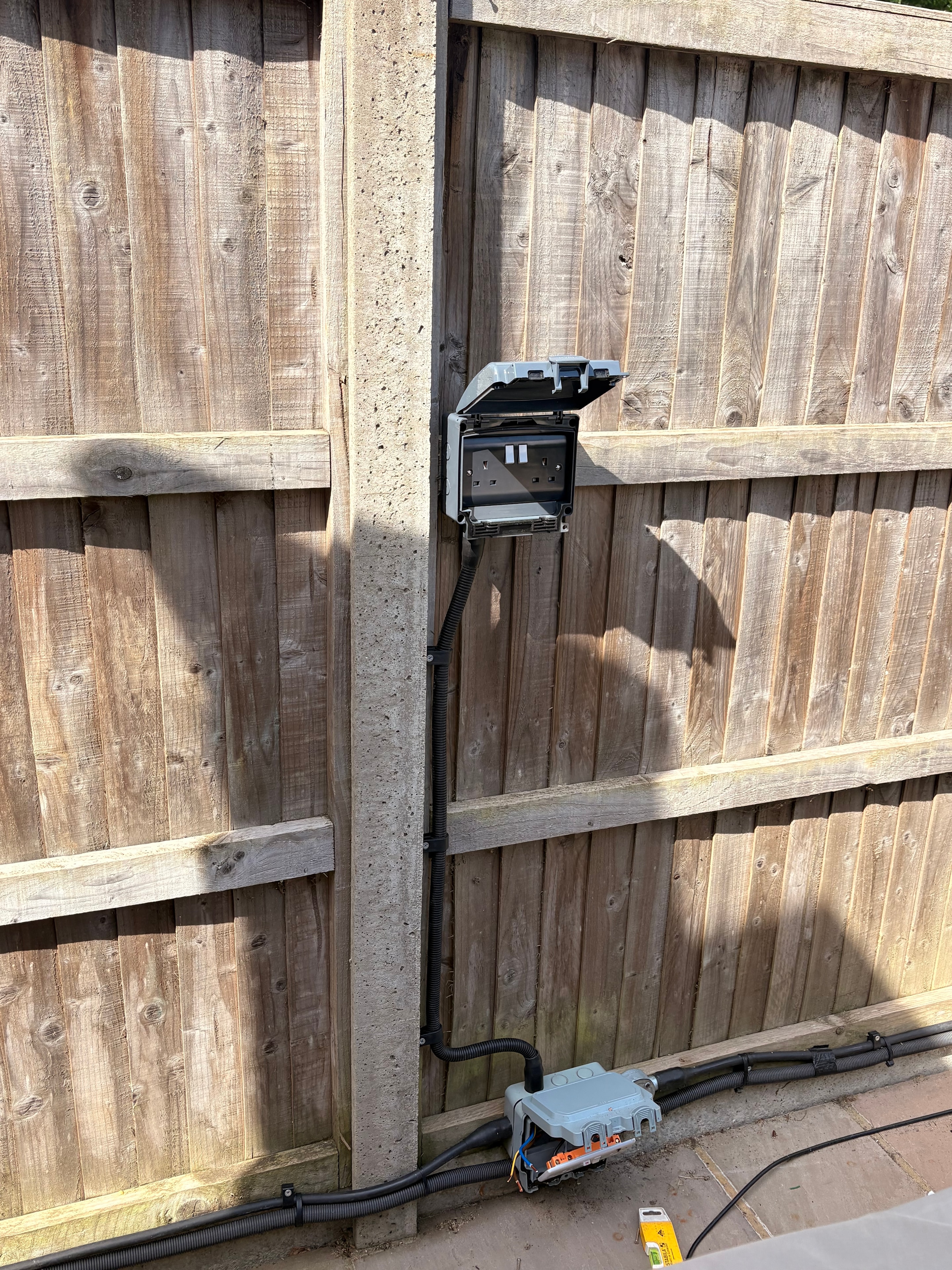 Weatherproof external socket installed on garden room in Surbiton — IP-rated, RCD protected, fully certified