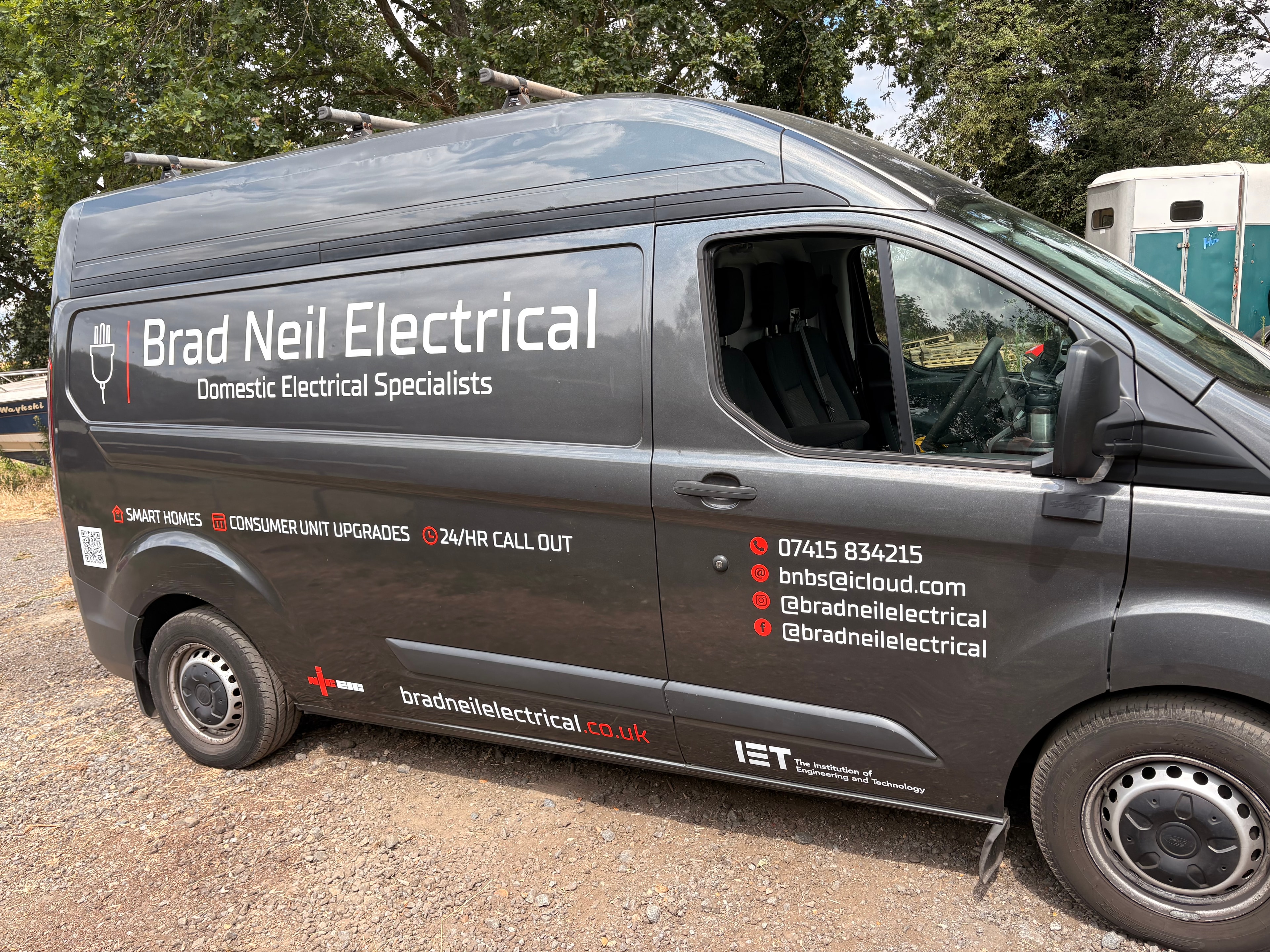 Brad Neil Electrical van — left side showing logo, Domestic Electrical Specialists strapline, Smart Homes, Consumer Unit Upgrades and 24hr Call Out services