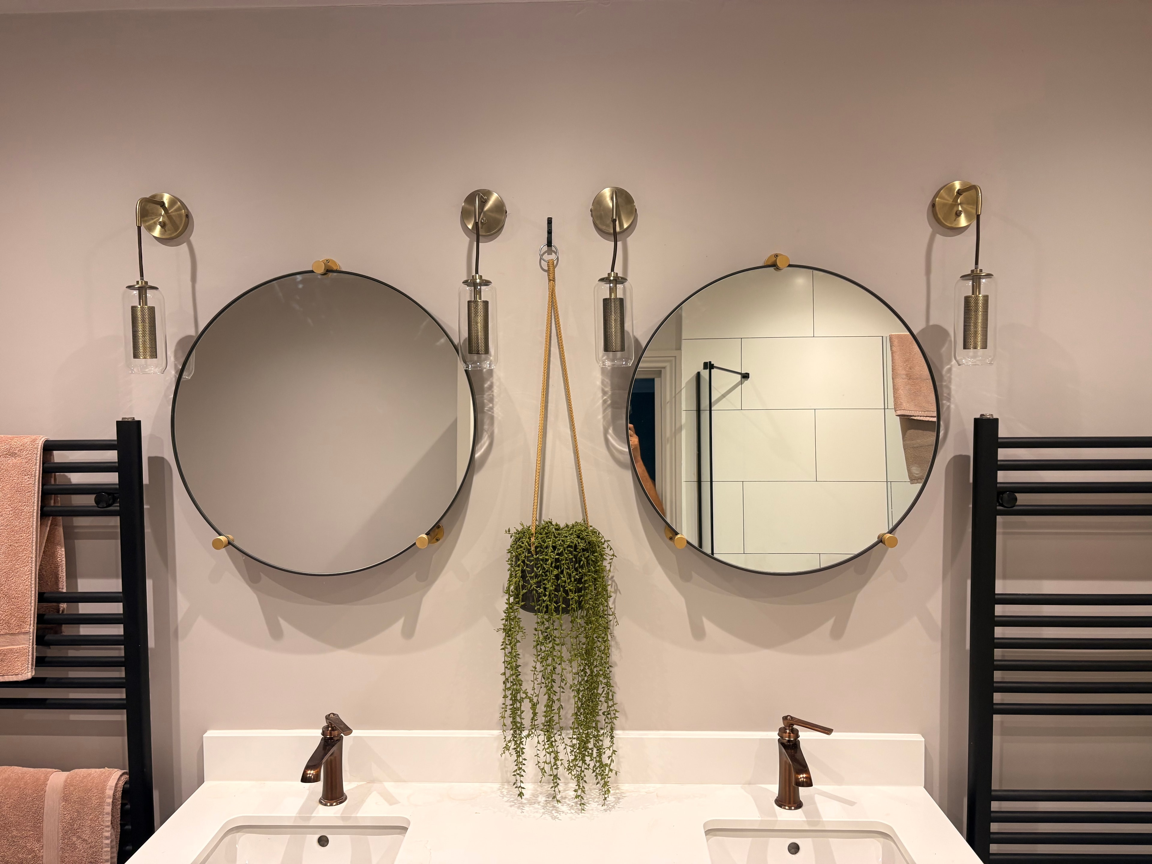 Bathroom before — original two wall lights installed either side of mirrors, Weybridge