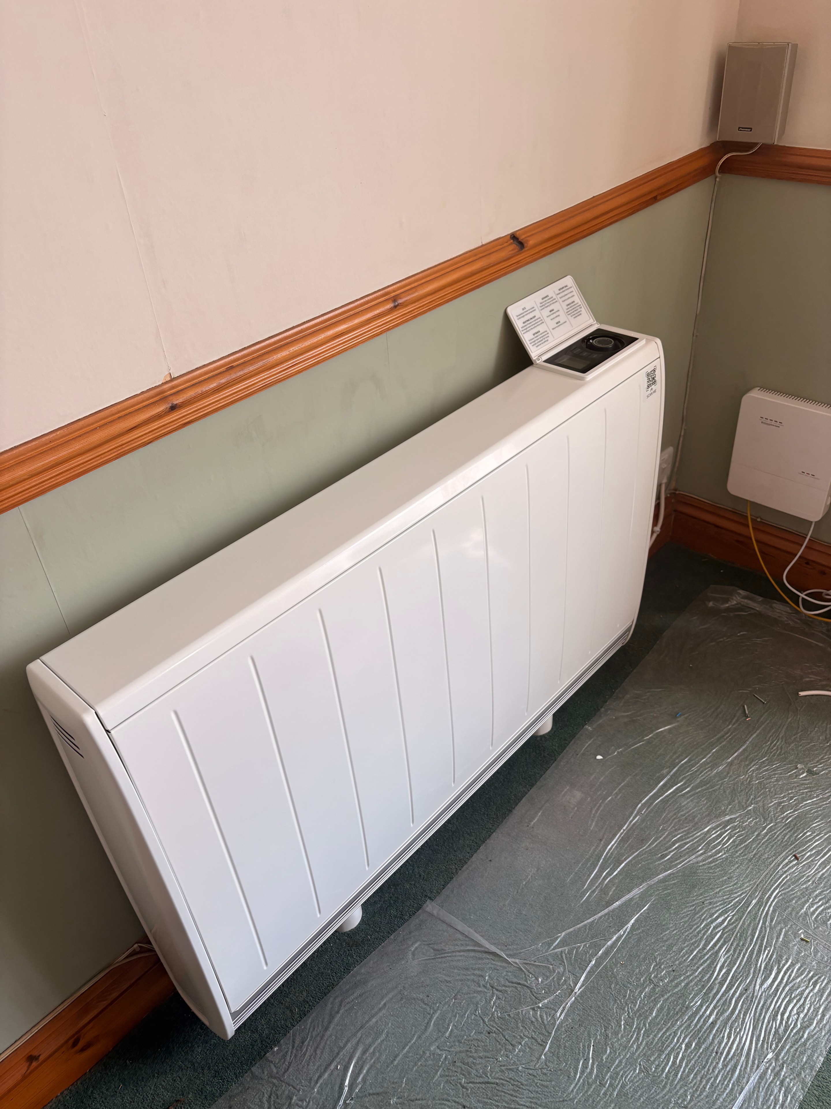 New Dimplex storage heater unit on the floor pre-installation, with remote control, ready to be mounted — Goodmayes government grant job